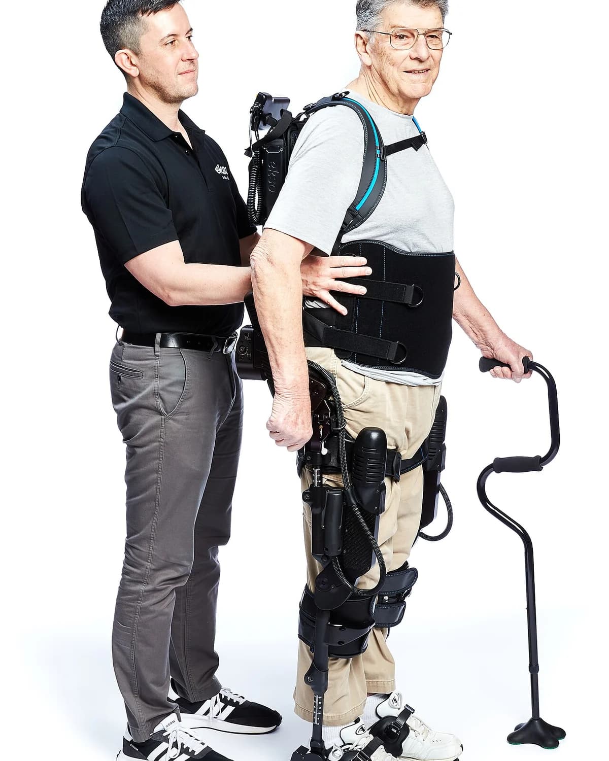 Clinician supporting a patient walking in an EksoNR exoskeleton