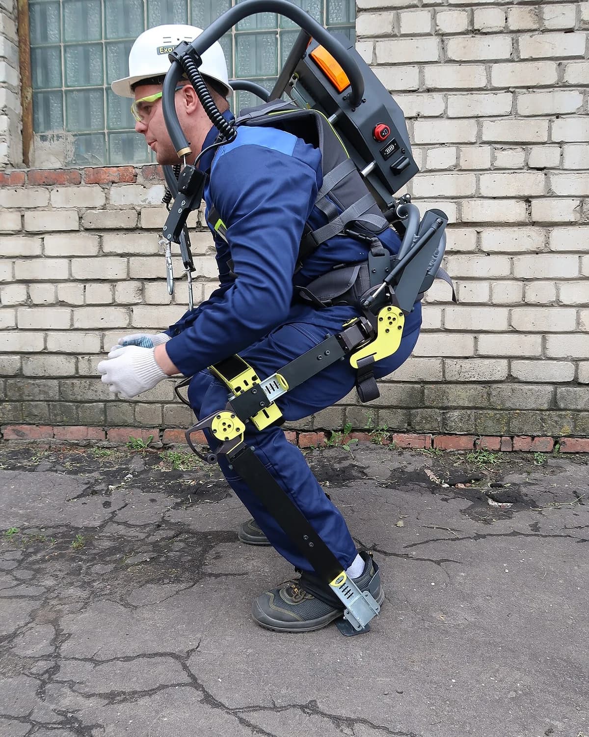 A worker crouching while wearing the ExoHeaver passive industrial exoskeleton.